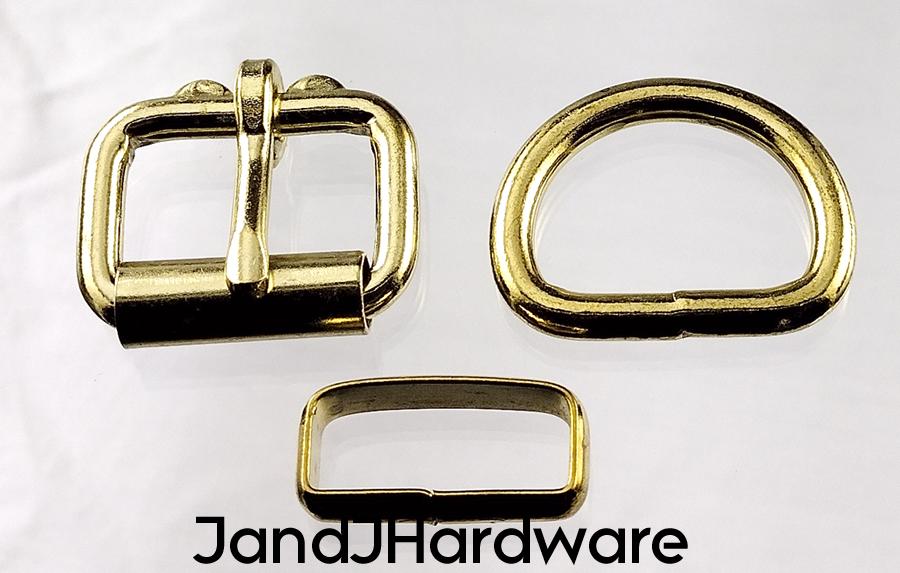 An image of a 1 inch deluxe brass plated maker pack with two each of a brass plated heel bar bucke, D ring, and deluxe belt keeper.