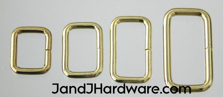 An image of a group of belt keepers or wire loops in brass plate from 1/2 to 1 1/2 inch in width.